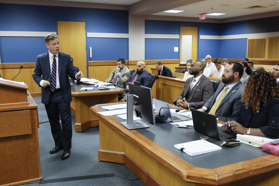 Attorney Brian Rafferty, left, representing Sidney Powell, argues before Fulton County Superior Court Judge Scott McAfee, not pictured, in Atlanta on Thursday, Sept. 14, 2023. Donald Trump will not face trial next month in Georgia after McAfee ruled Thursday that the former president and 16 others accused of illegally trying to overturn the results of the 2020 election will be tried separately from two lawyers in the case. Lawyers Sidney Powell and Kenneth Chesebro had filed demands for a speedy trial, and McAfee set their trial to begin Oct. 23. (Miguel Martinez/Atlanta Journal-Constitution via AP, Pool)