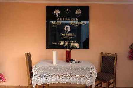 Pictures of deceased people are seen inside a chapel at a cemetery in the village of Smoljinac, Serbia, October 25, 2016. REUTERS/Marko Djurica