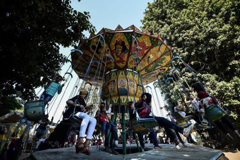 <p>Egyptians ride a merry-go-round at a park to celebrate the third day of Eid el-Adha in the city of Qanater Al-Khayria in the province of Qalioubia (AFP Photo/Mohamed el-Shahed) </p>