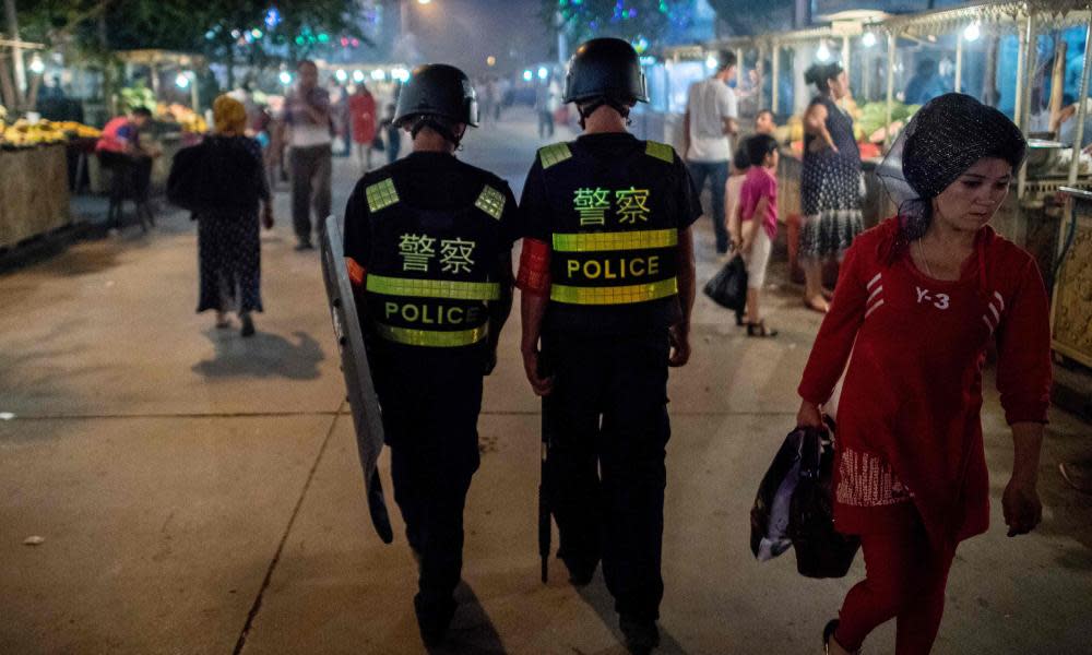 Police patrol a night food market in China’s Xinjiang Uighur Autonomous Region.