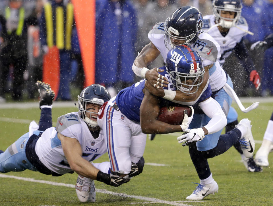 New York Giants wide receiver Jawill Davis, center, is tackled by Tennessee Titans inside linebacker Will Compton, left, and free safety Kevin Byard during the first half of an NFL football game Sunday, Dec. 16, 2018, in East Rutherford, N.J. (AP Photo)