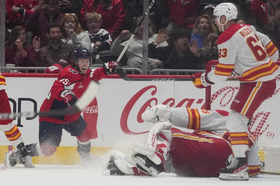 Washington Capitals center Matthew Phillips celebrates his goal past Calgary Flames goaltender Jacob Markstrom in the second period of an NHL hockey game, Monday, Oct. 16, 2023, in Washington. (AP Photo/Alex Brandon)