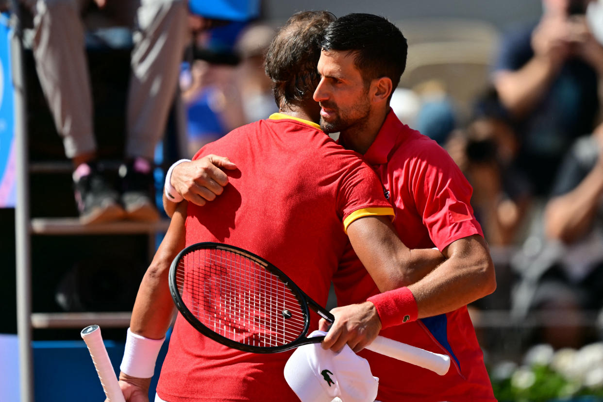 Winner, Serbia's Novak Djokovic (R) embraces Spain's Rafael Nadal (L) after their men's singles second round tennis match on Court Philippe-Chatrier at the Roland-Garros Stadium at the Paris 2024 Olympic Games, in Paris on July 29, 2024. (Photo by Martin  BERNETTI / AFP) (Photo by MARTIN  BERNETTI/AFP via Getty Images)