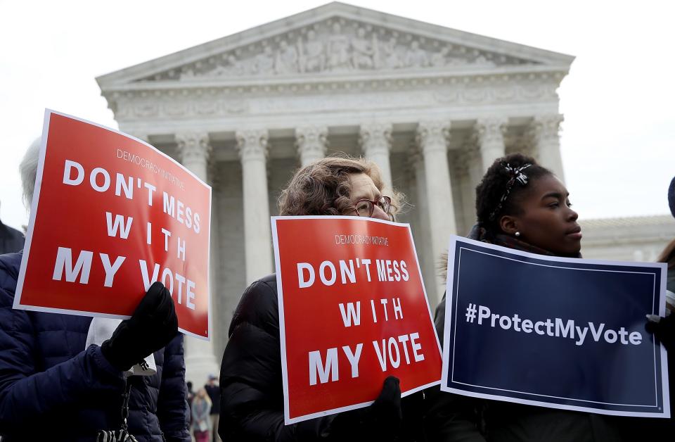 Protesters gather in front of the Supreme Court in 2018, rallying against voter roll purges.