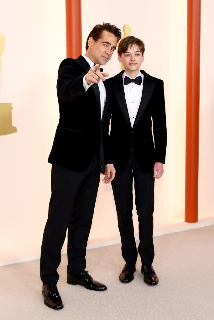 Colin Farrell gesturing and Henry Tadeusz Farrell on the red carpet