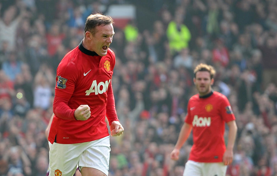 Manchester United's Wayne Rooney, foreground, celebrates after scoring his team's second goal against Aston Villa, during their English Premier League soccer match at Old Trafford Stadium, Manchester, England, Saturday March 29, 2014. (AP Photo/PA, Martin Rickett) UNITED KINGDOM OUT