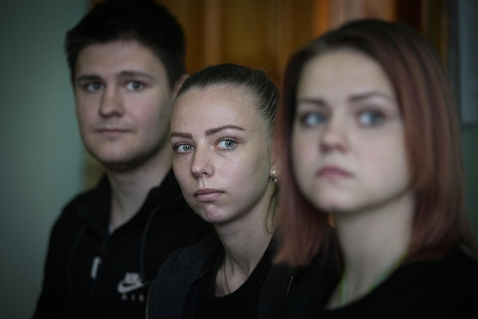 Evacuees from Mariupol, Sergei Mull, left; his wife, Daria Mull, center; and his sister's daughter, Maria Bobrushova, sit together during an interview at the Sosnovy Bor (Pine Forest) sanatorium near Gavrilov-Yam, Yaroslavl region, Russia, about 240 kilometers (150 miles) northeast of Moscow, on Tuesday, April 12, 2022. Olga Zabelina's family decided one day to get in their car under bomb attacks and run away. "Attacks persisted, shells fell in houses, on people. The only car showed up in our district, I asked them to take me with them. We got in our car as well and left," Zabelina says. (AP Photo/Alexander Zemlianichenko)