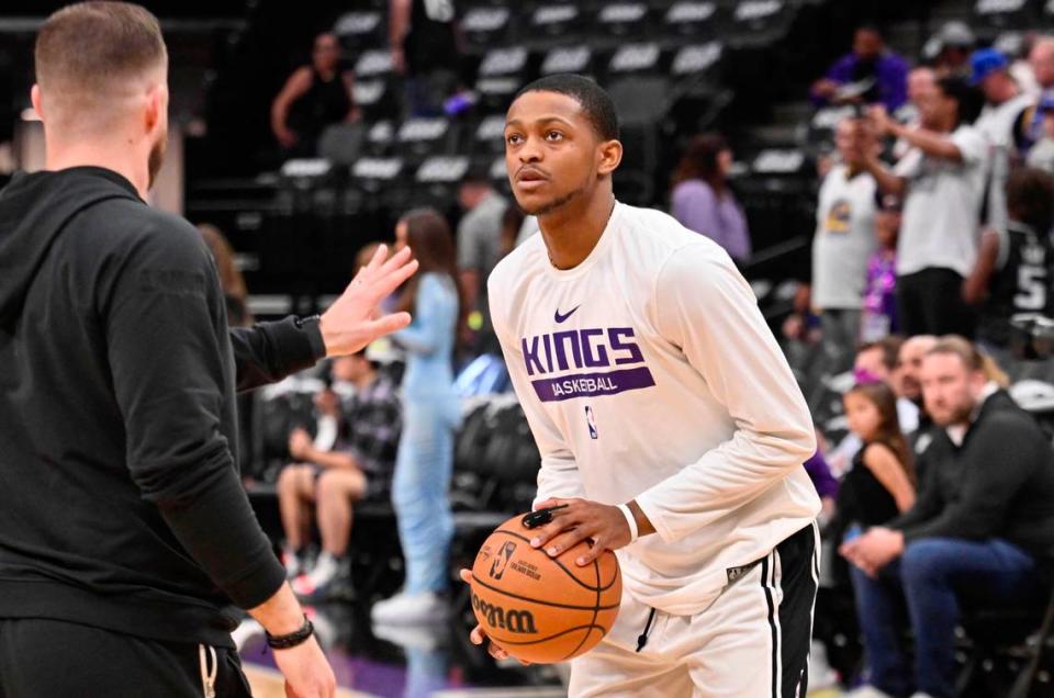 Kings point guard De’Aaron Fox warms up before Game 5 during Game 5 of the first-round NBA playoff series against the Golden State Warriors on Wednesday at Golden 1 Center, after suffering an avulsion fracture to his index finger on his left shooting hand Monday.