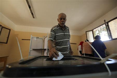 A man casts his ballot on the first day of the presidential elections inside a polling station in Cairo May 26, 2014. REUTERS/Mohamed Abd El Ghany