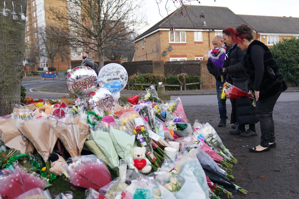 Women lay flowers among the tributes near to Babbs Mill Park in Kingshurst, Solihull, after the deaths of three boys aged eight, 10 and 11 who fell through ice into a lake in the West Midlands. Picture date: Tuesday December 13, 2022. (Photo by Jacob King/PA Images via Getty Images)