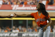 Gymnast Simone Biles is handed the ceremonial first pitch ball before Game 2 of the baseball World Series between the Houston Astros and the Washington Nationals Wednesday, Oct. 23, 2019, in Houston. (AP Photo/Matt Slocum)