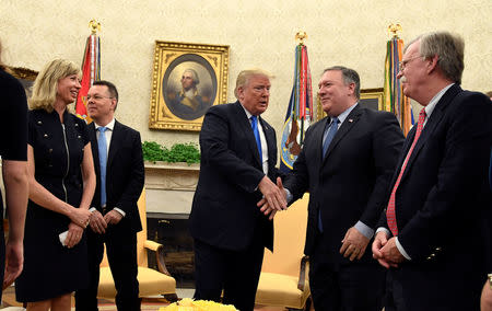 U.S. President Donald Trump shakes hands with Secretary of State Mike Pompeo as National Security Advisor John Bolton looks on, after welcoming Pastor Andrew Brunson, released from Turkish detention, in the Oval Office of the White House, Washington, U.S., October 13, 2018. REUTERS/Mike Theiler