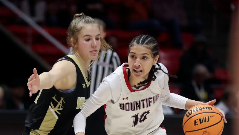 Bountiful’s Taylor Harvey dribbles around Wasatch High’s Danielle Garner during the 5A girls basketball state championship game at the Huntsman Center in Salt Lake City on Friday, March 1, 2024. Bountiful won 62-35.