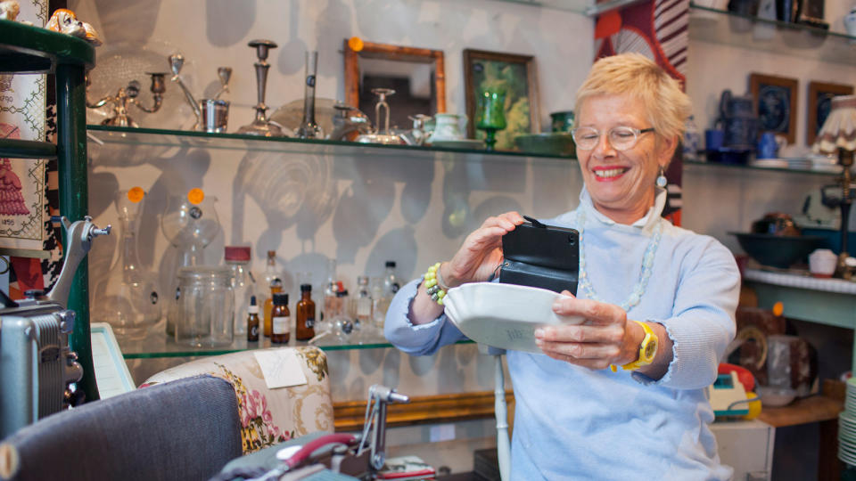 older woman photographing pot