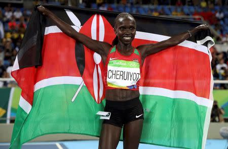 2016 Rio Olympics - Athletics - Final - Women's 5000m Final - Olympic Stadium - Rio de Janeiro, Brazil - 19/08/2016. Vivian Cheruiyot (KEN) of Kenya celebrates after winning gold. REUTERS/Phil Noble