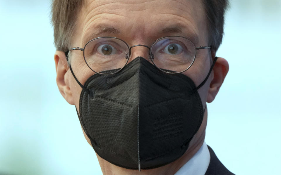 FILE -- German Health Minister Karl Lauterbach arrives for a press conference in Berlin, Germany, Friday, Aug. 12, 2022 on the current Corona situation in Germany. Germany's governing coalition is arguing over whether remaining coronavirus restrictions should be dropped after one of the country's top virologists was quoted as saying that the COVID-19 pandemic is over. (AP Photo/Michael Sohn, file)