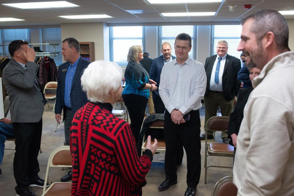 Former and present school superintendents, board members and education officials gather before the start of Friday's Kansas Board of Education special meeting.