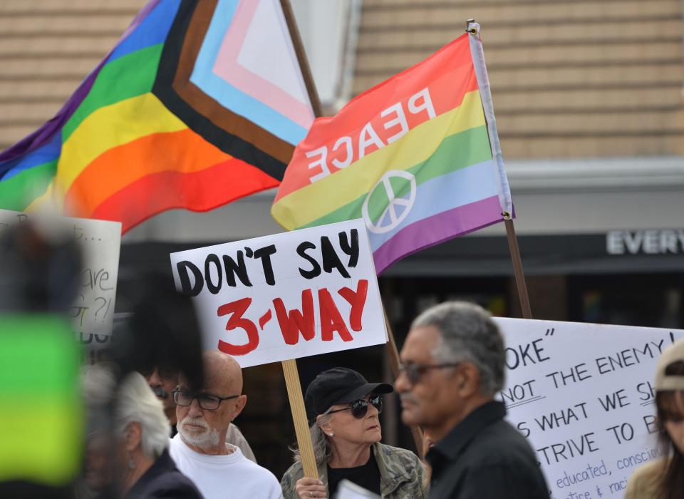 Protestors, including Judy Nadler of Sarasota, with her "Don't Say 3-way" sign, gather outside the Sarasota County School Board Tuesday evening, Dec. 12, 2023, calling for school board member Bridget Ziegler to resign. Following the demonstration, the school board approved a symbolic resolution calling for Ziegler to resign after admitting to involvement in a three-way sexual relationship.