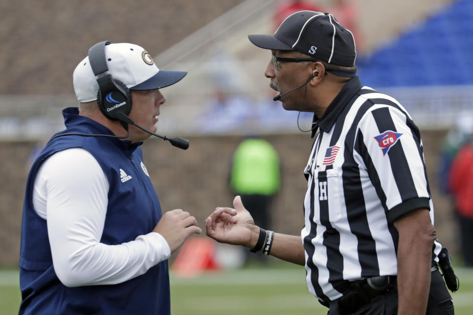 Georgia Tech head coach Geoff Collins discusses a call with an official during the second half of an NCAA college football game against Duke in Durham, N.C., Saturday, Oct. 9, 2021. (AP Photo/Chris Seward)