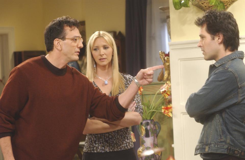 Phoebe Buffay (Lisa Kudrow, center) eventually chose Mike Hannigan (Paul Ruff, right) over David (Hank Azaria, left) in "Friends." (Photo: NBC via Getty Images)