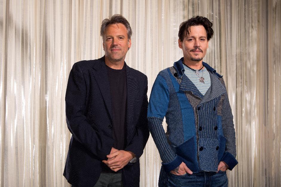 This Saturday, April 5, 2014 photo shows actor Johnny Depp, right, and director Walter Pfister during the "Transcendence" film press junket at the Four Seasons Hotel, in Los Angeles. For more than a decade the cinematographer Pfister has been bringing director Christopher Nolan's cinematic visions to life, but now he's the one calling the shots. His directorial debut "Transcendence" has many elements of a Nolan blockbuster, with eye-popping visual effects, a mind-bending story and an A-list lead in Depp. (Photo by Zach Cordner/Invision/AP)
