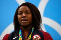 <p>Gold medalist Simone Manuel of the United States celebrates on the podium during the medal ceremony for the Women’s 100m Freestyle Final on Day 6 of the Rio 2016 Olympic Games at the Olympic Aquatics Stadium on August 11, 2016 in Rio de Janeiro, Brazil. (Getty) </p>