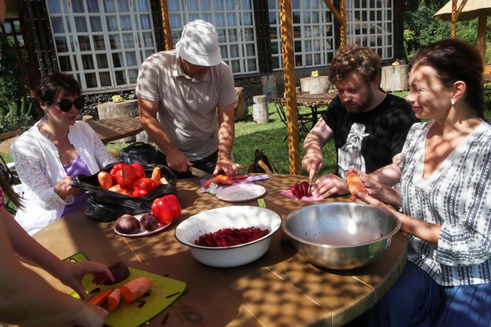 TV presenter of "Snidanok 1+1" Kostya Hrubych cooks borsch with apples in the "Victory" field kitchen together with military personnel in Bila Tserkva in north-central Ukraine on Aug. 28, 2022. The borsch was given to the military of the 72nd Separate Mechanized Brigade. (Photo by Pavlo Bahmut/ Ukrinform/Future Publishing via Getty Images)