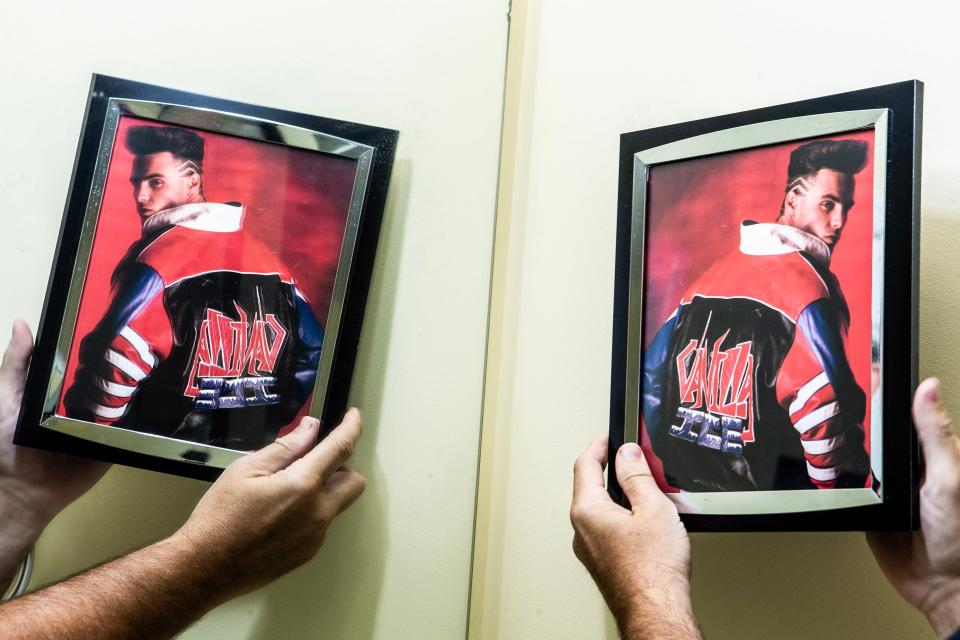 Chad Hastings holds up a picture of Vanilla Ice, which hangs on the wall of "The Ice House," a bathroom at his home in Magnolia, Monday, July 17, 2023. The bathroom is decorated with memorabilia of Vanilla Ice and Ice Cube.