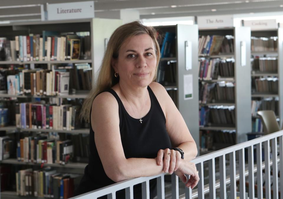 Mamaroneck Library Director Jennifer O'Neill, pictured in the library on April 21, 2023, was recently suspended without pay.  Her lawyers say this was retaliation for reporting that a Library Board member "involved in a misogynistic pattern of sexual harassment against her."