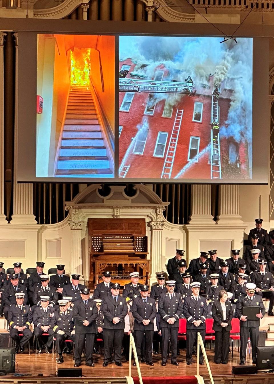 Photos from the deadly March 28 fire at the Royal Crown rooming house in New Bedford are shown Tuesday at the annual state Firefighter of the Year Awards in Worcester, as New Bedford firefighters involved in that day's response are honored with awards.