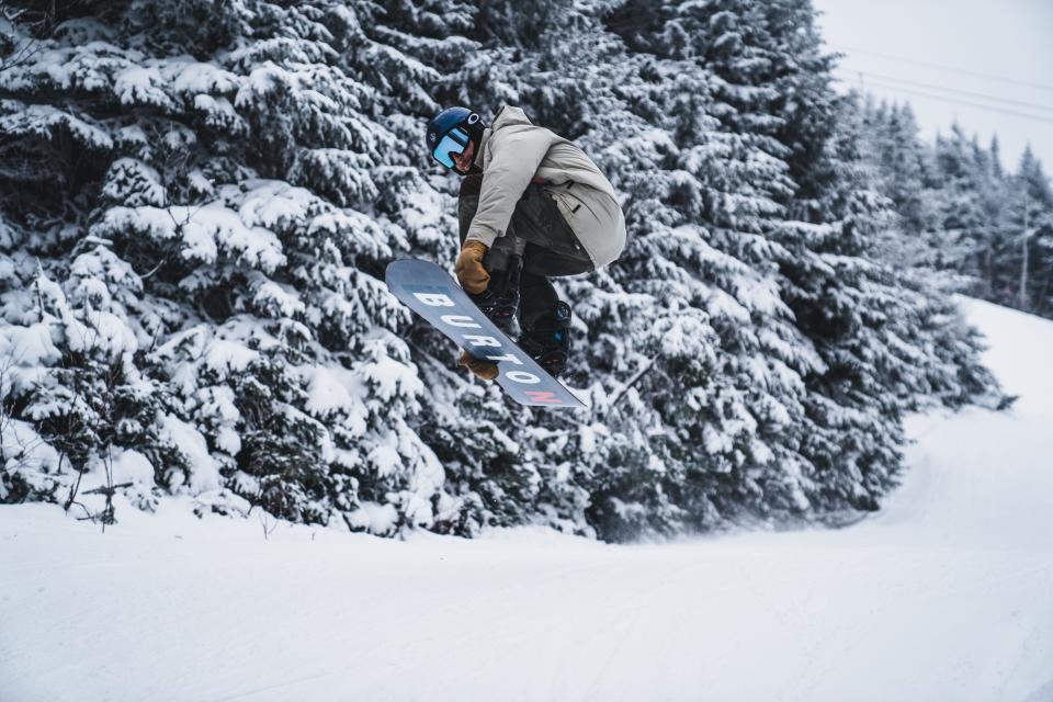 Snowboarder takes to the air at Bolton Valley Resort in Richmond.
