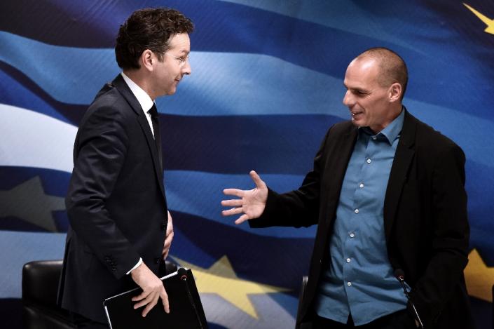 Jeroen Dijsselbloem (left) says reform proposals by Yannis Varoufakis (right) are "far from complete" (AFP Photo/Aris Messinis)
