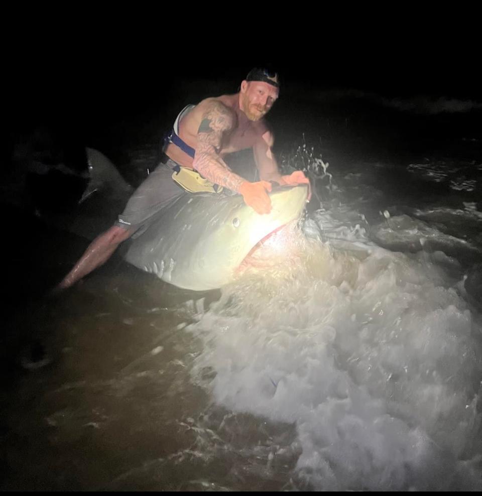 Christian Haltermann reeled in a 12.5-foot tiger shark while fishing at the Padre Island National Seashore with his son in May 2022.