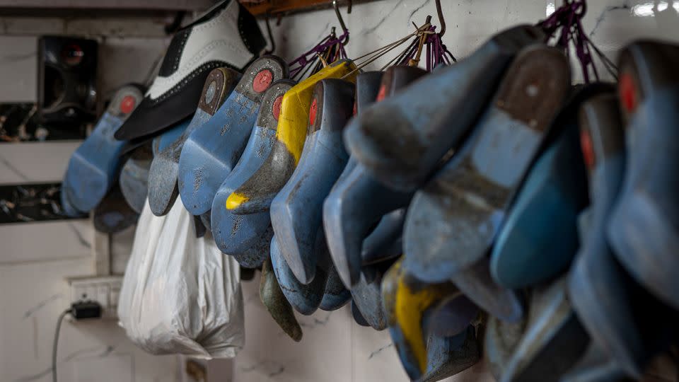 Shoe models hang in Shah’s workshop in Mumbai on April 14, 2024. - Noemi Cassanelli/CNN