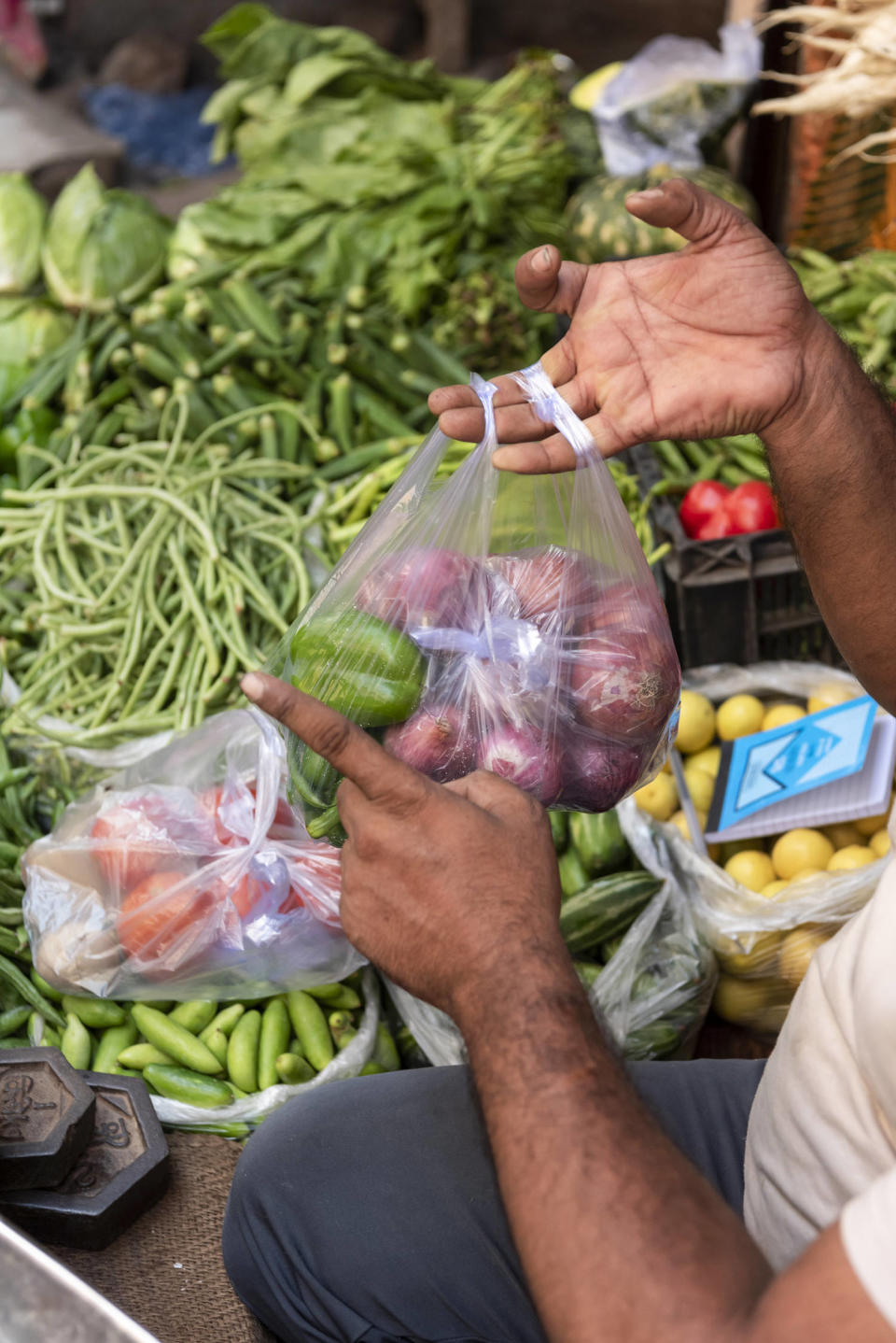 A grocery seller packs vegetables in the local market in New Delhi, India, on Sept. 5, 2023. (Saumya Khandelwal for NBC News)