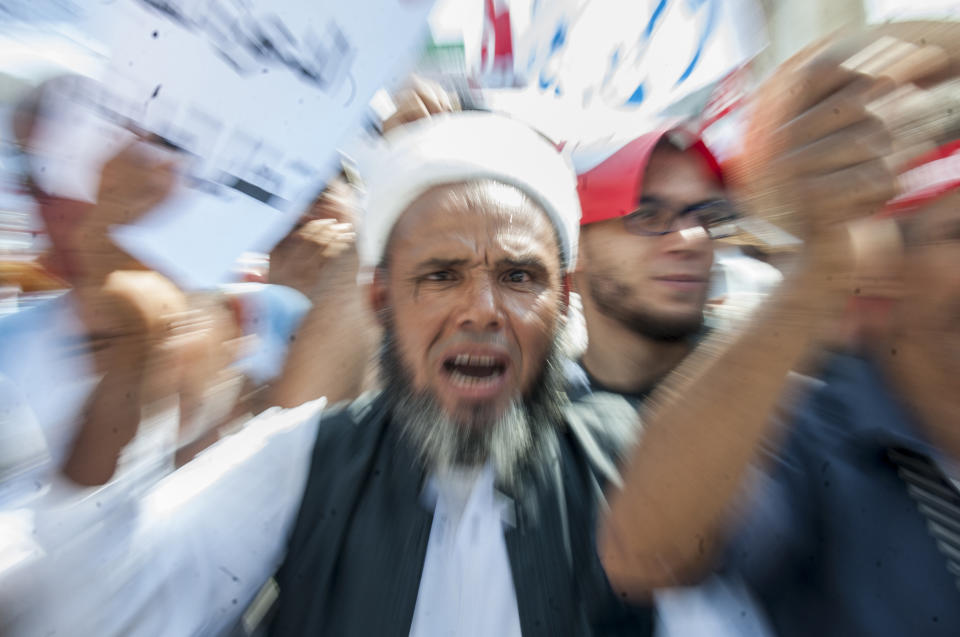 A man shouts during a demonstration in Tunis, Saturday Aug 11, 2018. Thousands of Muslim fundamentalists have held an hours-long protest in front of the nation's parliament to decry proposals in a government report on gender equality. (AP Photo/Hassene Dridi)