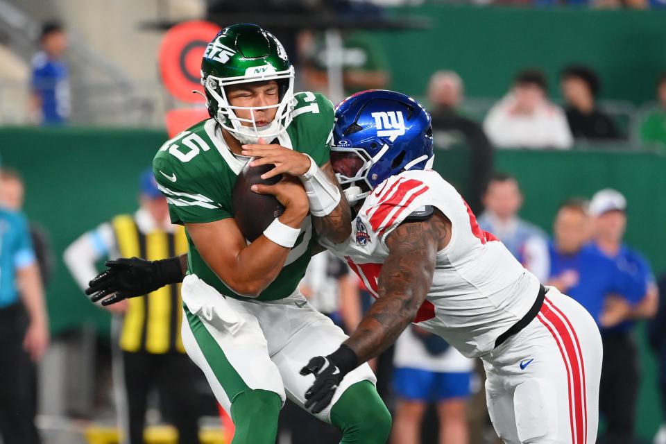 Aug 24, 2024; East Rutherford, New Jersey, USA; New York Giants linebacker Tomon Fox (45) sacks New York Jets quarterback Adrain Martinez (15) during the first half at MetLife Stadium. Mandatory Credit: Rich Barnes-USA TODAY Sports