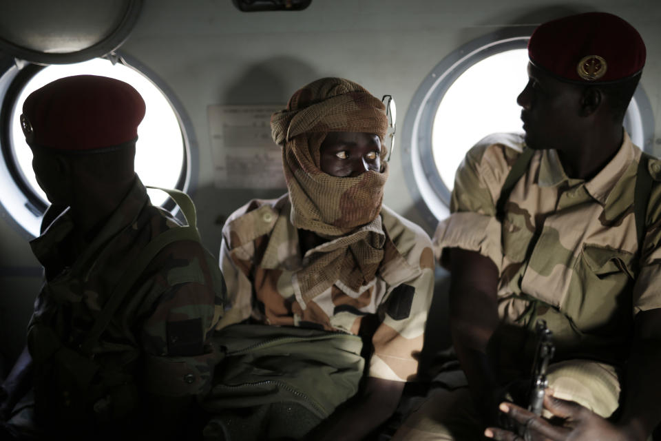 Chadian soldiers returning from the Nigerian city of Damasak, Nigeria, sit in a helicopter Wednesday March 18, 2015. (AP Photo/Jerome Delay)