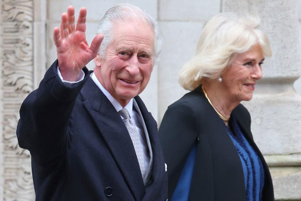 <p>Chris Jackson/Getty Images</p> King Charles III waves as he departs with Queen Camilla after receiving treatment for an enlarged prostate at The London Clinic on January 29, 2024 in London, England. 