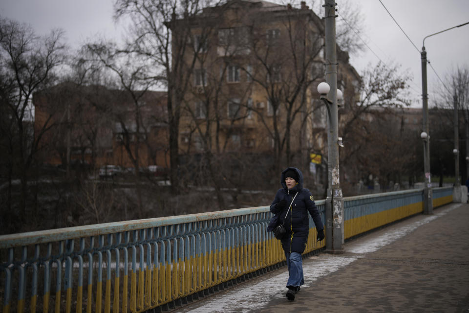 A woman walks in a street in Kryvyi Rih, Ukraine, Sunday, Jan. 29, 2023. (AP Photo/Daniel Cole)