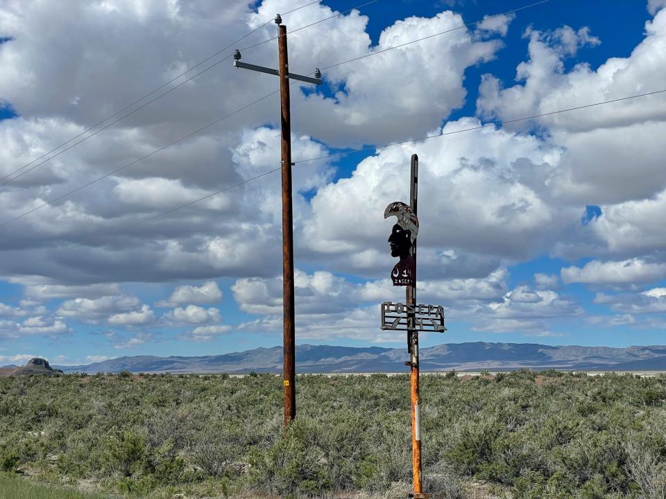 A small, rusty sign indicates visitors are on the right path to Iosepa.