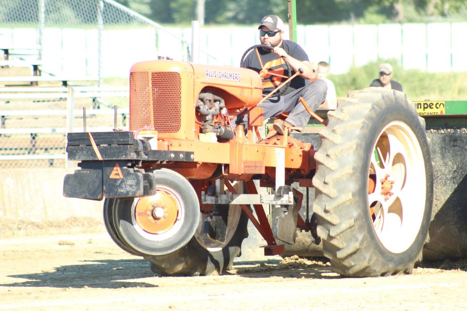 Mike Synder drives a 1946 Allis-Chalmers tractor at the antique tractor pull on Friday evening, part of the Crawford Farm Machinery Show at the Crawford County Fairgrounds.