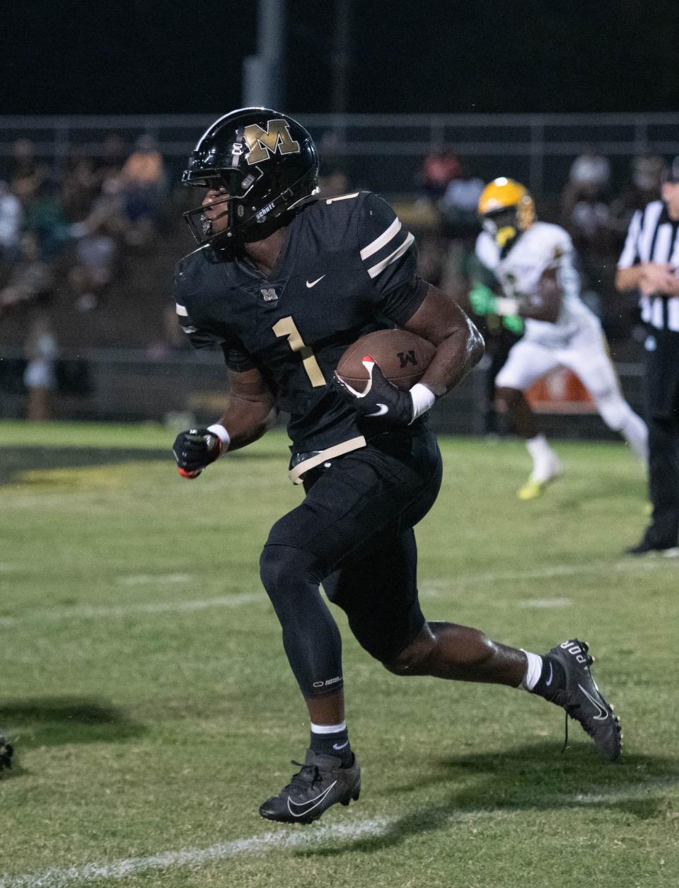 Raymond Cottrell (1) carries the ball during the Pensacola Catholic vs Milton football game at Milton High School on Thursday, Sept. 1, 2022.