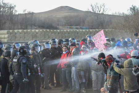 Police mace protesters during a demonstration against the Dakota Access pipeline near the Standing Rock Indian Reservation in Mandan, North Dakota, November 15, 2016. REUTERS/Stephanie Keith