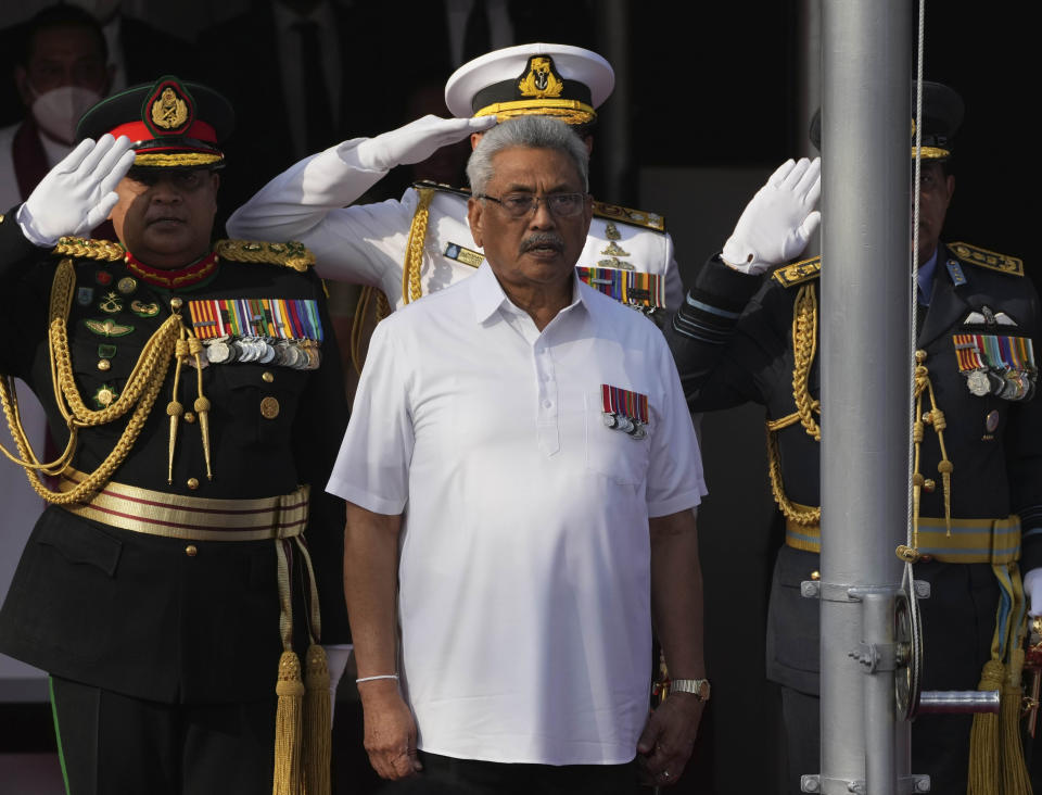 FILE- Sri Lankan president Gotabaya Rajapaksa sings the national anthem of Sri Lanka during the country's Independence Day celebration in Colombo, Sri Lanka, Feb. 4, 2022. Sri Lanka’s economic collapse has been blamed on its president and his family, and demonstrators have for months demanded his resignation, the last of six family members still clinging to power. On Sunday, President Gotabaya Rajapaksa was nowhere to be found, his official residence occupied by thousands of angry citizens who were no longer taking no for an answer, now squatting in his bedroom and swimming in his pool. (AP Photo/Eranga Jayawardena, file)