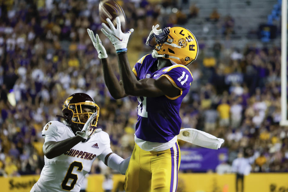 LSU wide receiver Brian Thomas Jr. (11) catches a pass next to Central Michigan defensive back Daedae Hill (6) during the second quarter of an NCAA college football game in Baton Rouge, La,. Saturday, Sept. 18, 2021. (AP Photo/Derick Hingle)