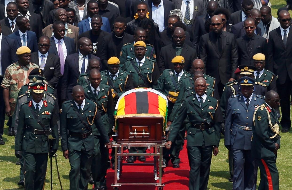 The body Robert Mugabe is brought to Zimbabwe's national sports stadium for a state funeral in the capital Harare: REUTERS