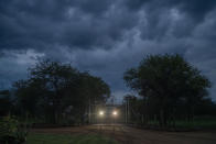 Customers arrive under storm clouds at the Tamboti Bush Lodge in the Dinokeng game reserve near Hammanskraal, South Africa, Saturday Dec. 4, 2021. Recent travel bans imposed on South Africa and neighboring countries as a result of the discovery of the omicron variant in southern Africa have hammered the country’s safari business, already hard hit by the pandemic. (AP Photo/Jerome Delay)