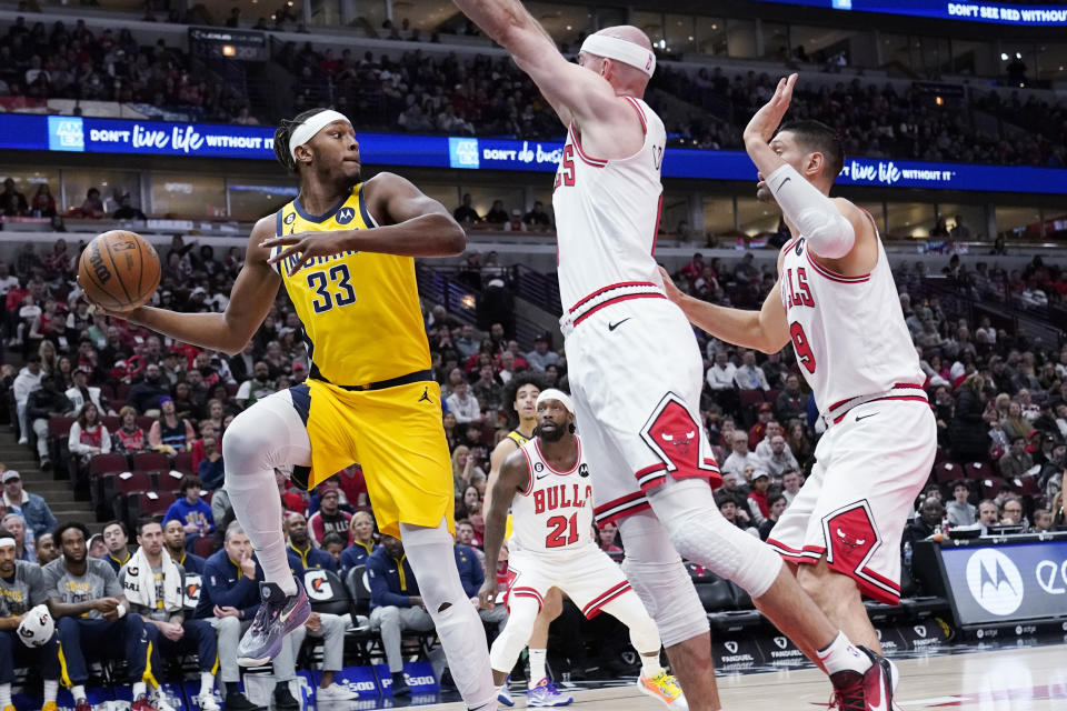 Indiana Pacers center Myles Turner, left, looks to pass against Chicago Bulls guard Alex Caruso, center, and center Nikola Vucevic during the first half of an NBA basketball game in Chicago, Sunday, March 5, 2023. (AP Photo/Nam Y. Huh)