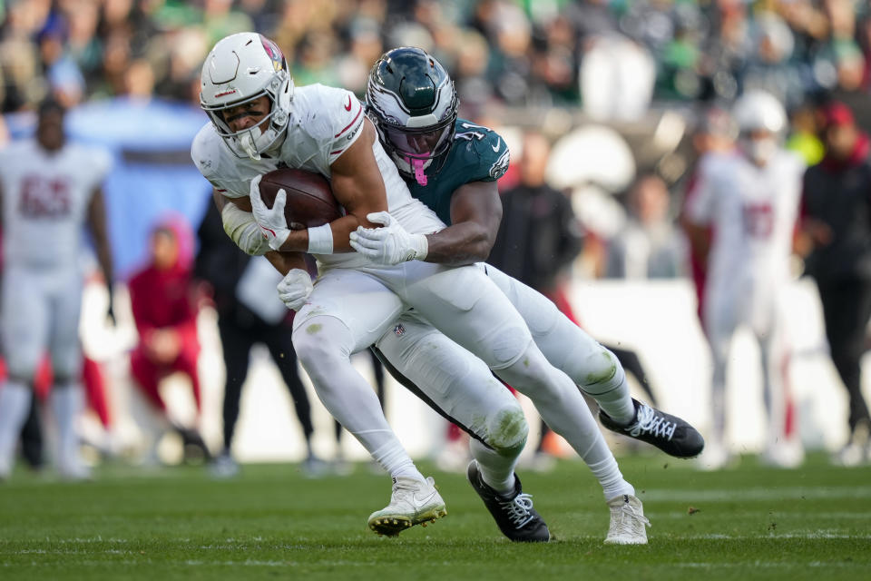 Arizona Cardinals wide receiver Michael Wilson, front, is tackled by Philadelphia Eagles linebacker Nicholas Morrow after making a catch during the second half of an NFL football game, Sunday, Dec. 31, 2023, in Philadelphia. (AP Photo/Matt Slocum)